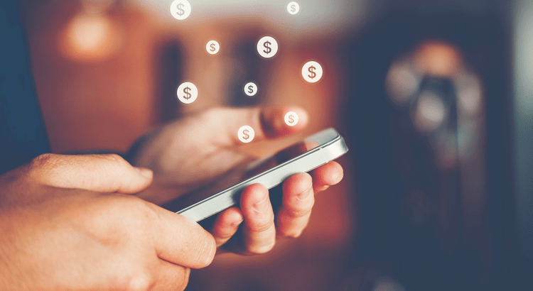 man looking at his phone about renting vs buying in charlotte