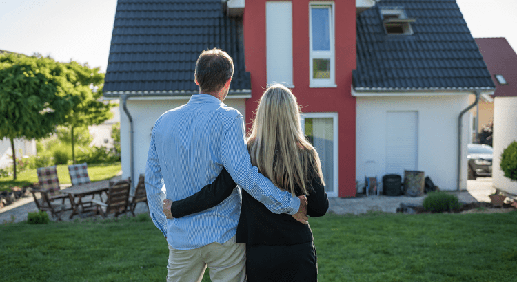 couple looking at a charlotte house guessing if buying or waiting